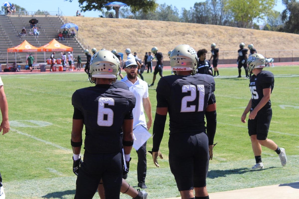 #6 Zach Valcarcel and #21 Jude Mendoza 
watching their team.
