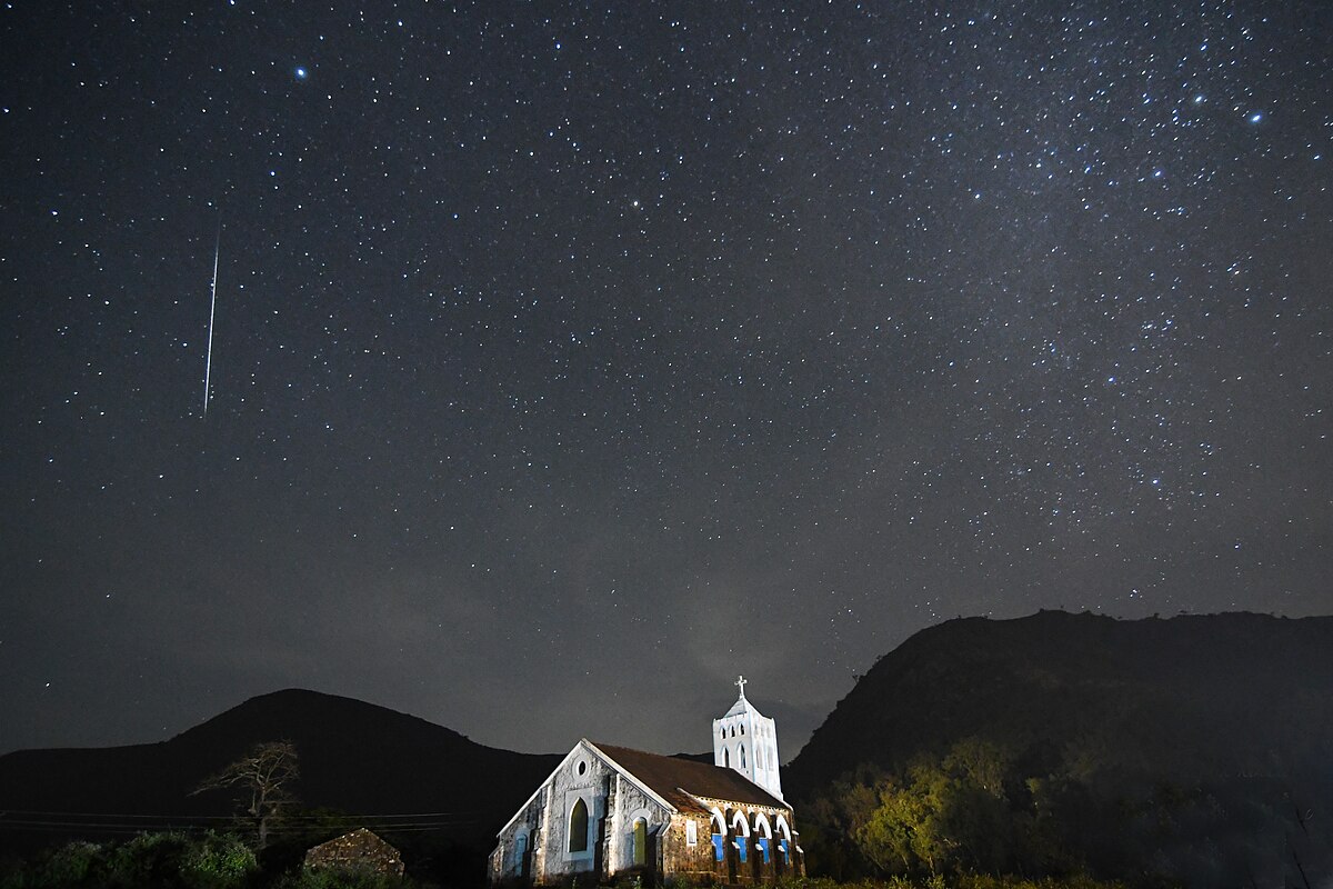 Geminid meteor shower over an old church 