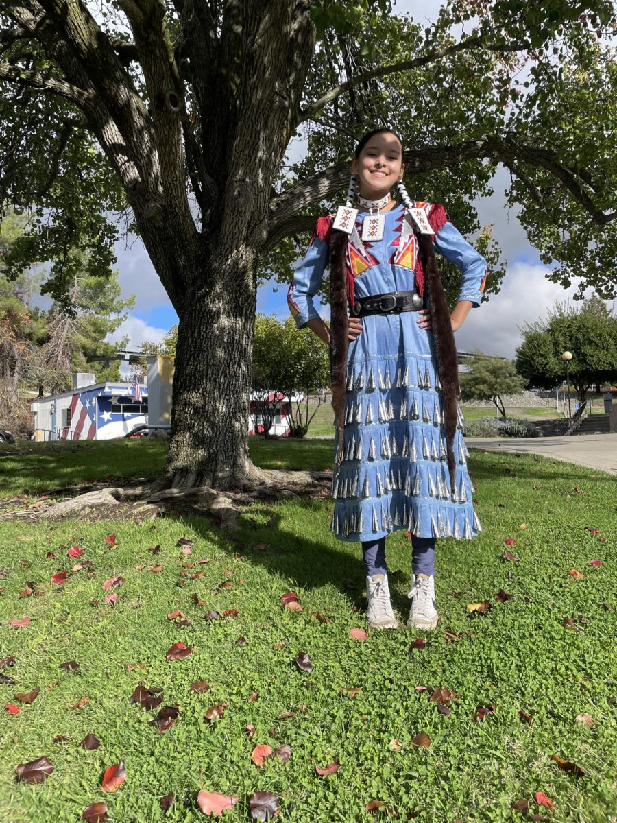 Mickaela Watkins poses in her jingle dress outside the Native Center. (Oroville, Ca.) Nov, 18, 2025