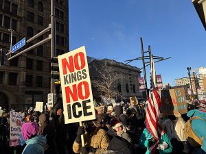 a crowd at a protest, with a sign that reads "NO KINGS NO ICE", taken on January 30, 2026
