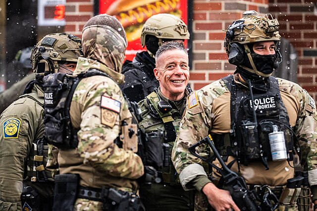 Border Commander Greg Bovino stands outside a South Minneapolis gas station with BORTAC officers, January 29, 2026, Creative Commons 4.0