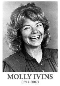 Black and white headshot photo of cheery young woman, with happy eyes and wide smile.