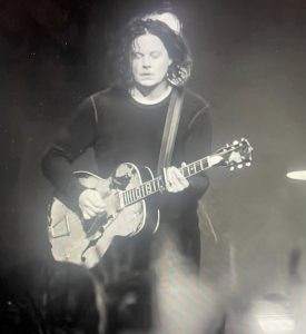 a black and white picture of Jack White on stage