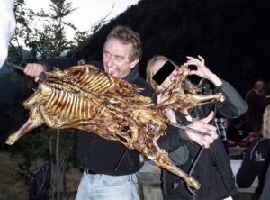 A picture with RFK Jr. and an unknown woman, holding a dead "goat" with their hands, and mouths. A screenshot of a picture of a post via Instagram.