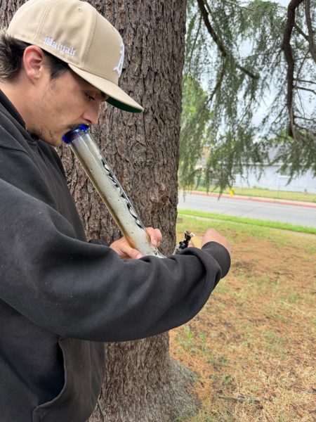 Octavio is pictured taking a drag out of his locally blown bong after a long and stressful day.