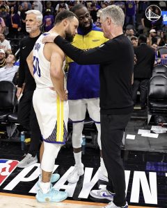 Steph Curry, on the left, with coach Steve Kerr. Kerr is giving Curry (#30) a pat on the back, in this photo. 