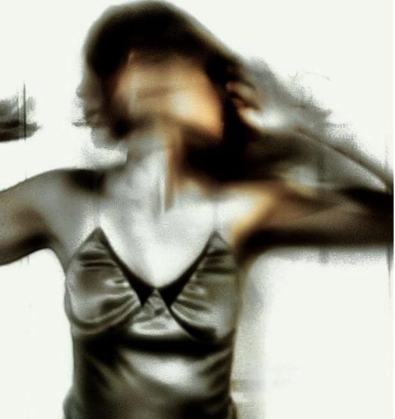 An artsy portrait. A girl seen with three faces, in a whirlwind of emotion.